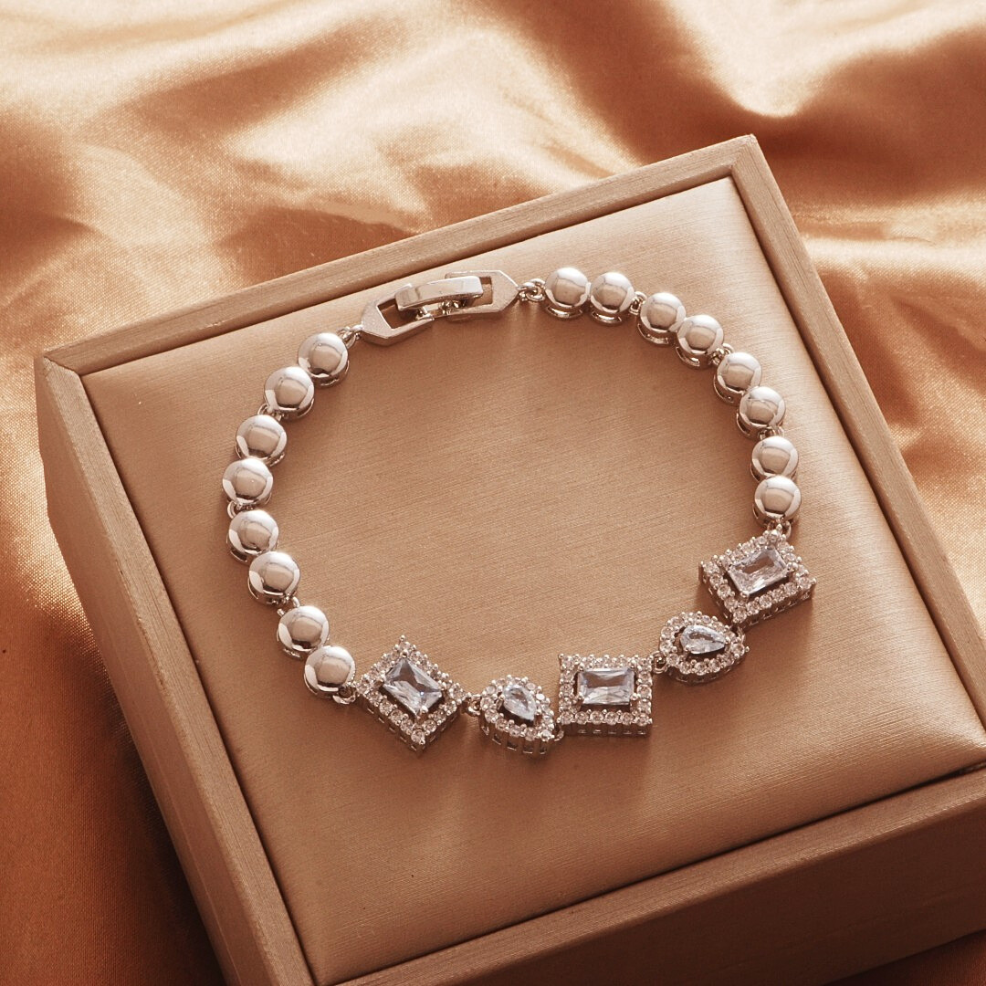 Silver Tone bracelet, style TSL004, with rectangular and teardrop halo centers with rounded links and a clasp.