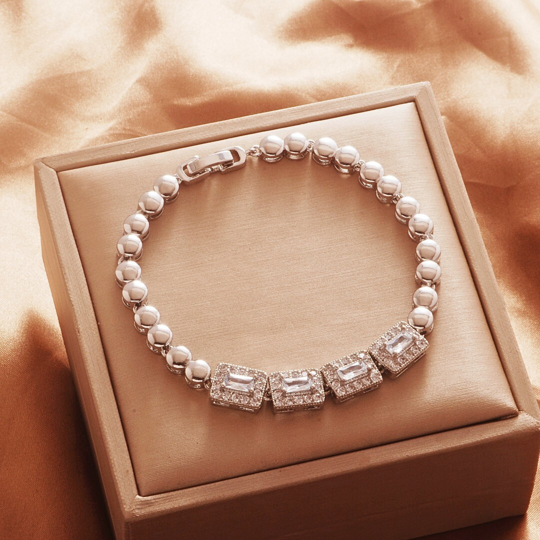Silver Tone bracelet, style TSL005, with rectangular halo centers and rounded links and a clasp.
