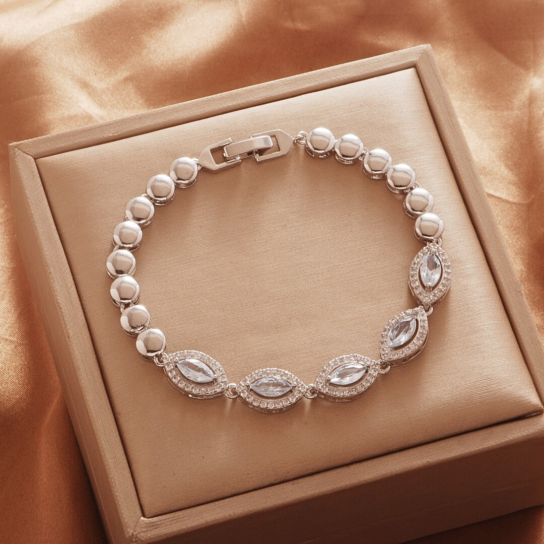Silver Tone bracelet, style TSL007, with marquise halo centers and rounded links and a clasp.