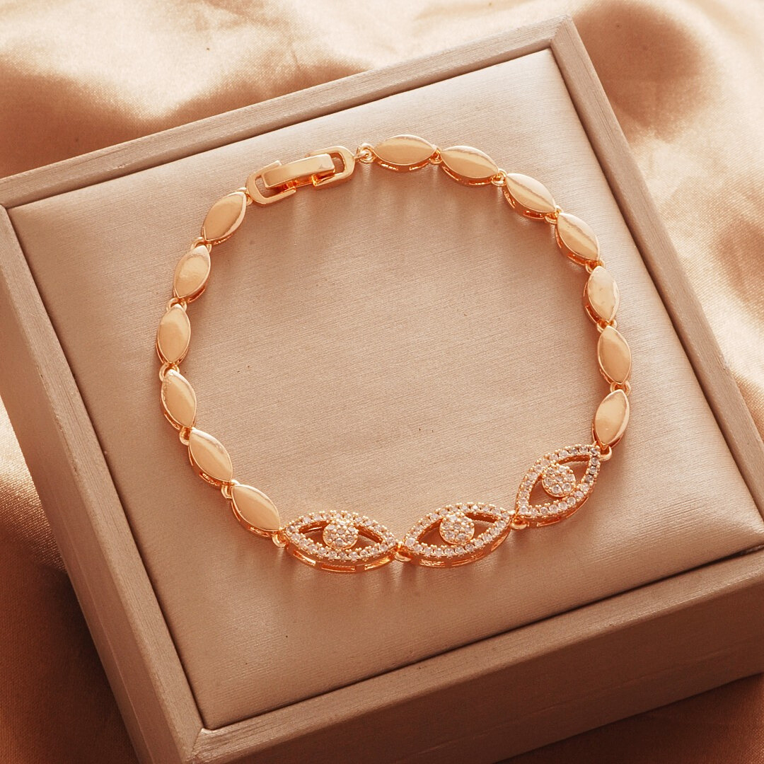 Gold Tone bracelet, style TSL008, with marquise halo centers and smooth oval links and a clasp.