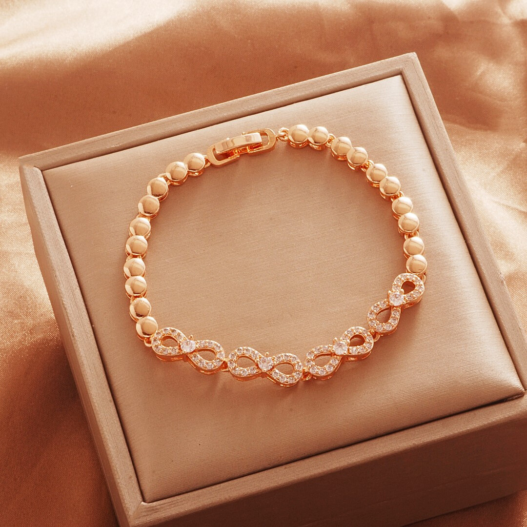 Gold Tone bracelet, style TSL009, with oval halo centers and rounded links and a clasp.