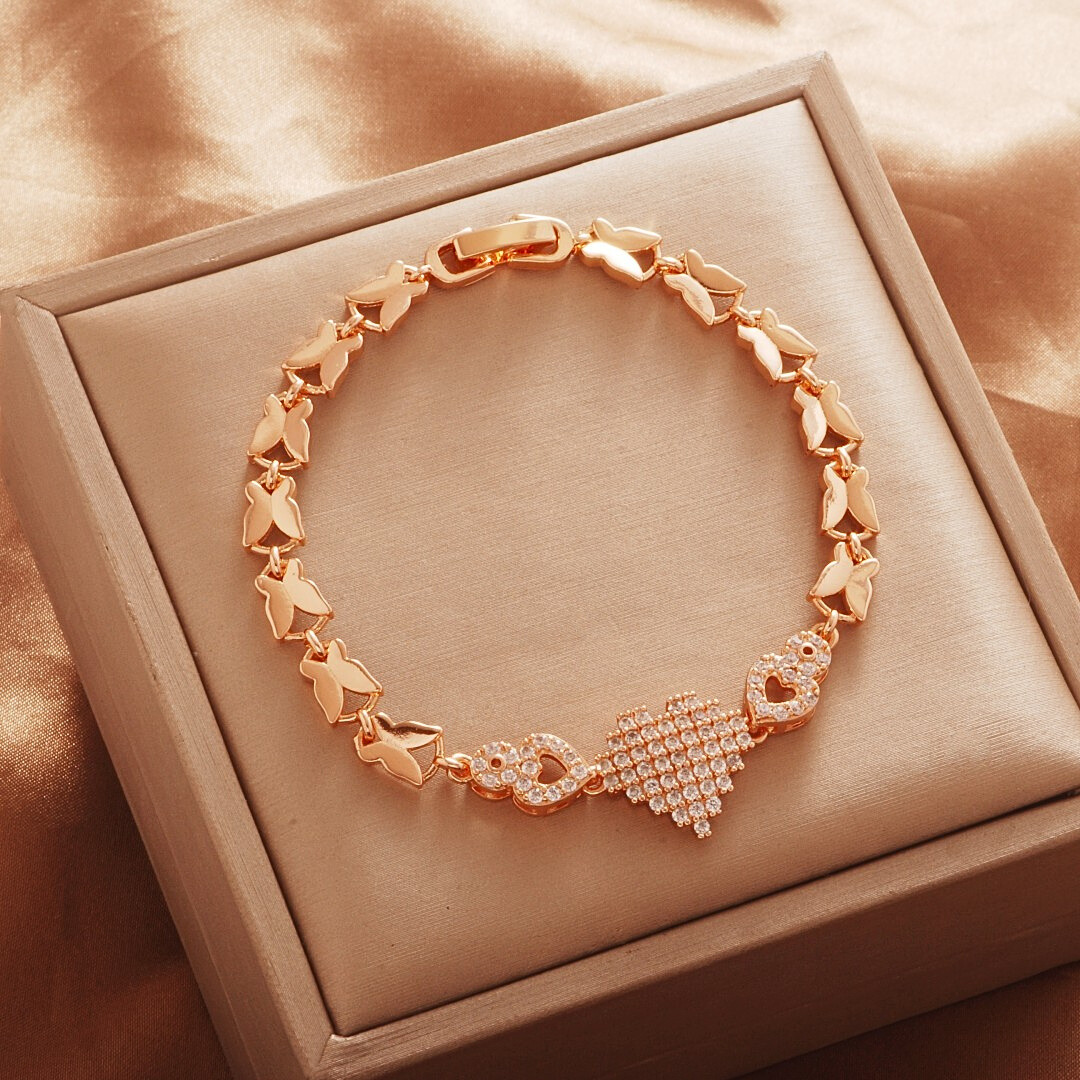 Gold Tone bracelet, style TSL014, with a triangular stone-set center and butterfly-shaped links and a clasp.
