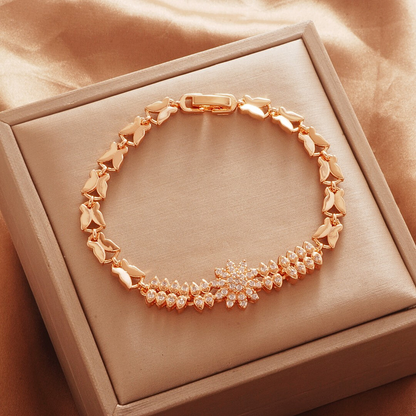 Gold Tone bracelet, style TSL017, with a flower center and butterfly-shaped links and a clasp.