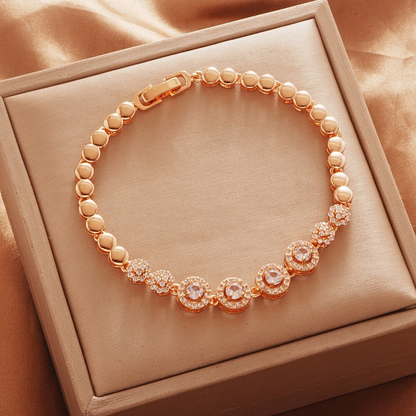 Gold Tone bracelet, style TSL021, with circular halo centers and rounded links and a clasp.