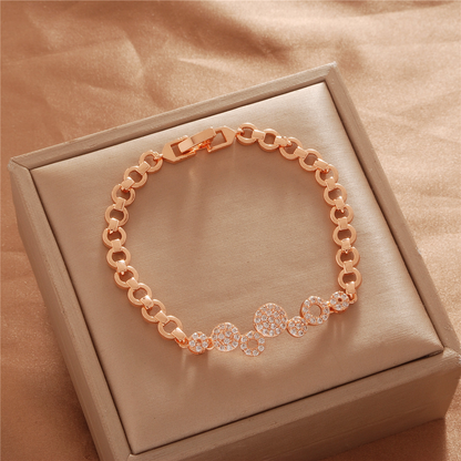 Gold Tone bracelet, style TSL024, with round stone-set center discs and open rounded links and a clasp.