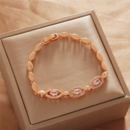 Gold Tone bracelet, style TSL025, with marquise-shaped stone-set centers and smooth oval links and a clasp.