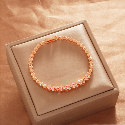 Gold Tone bracelet, style TSL026, with small repeating flower-like stone-set links and a clasp.