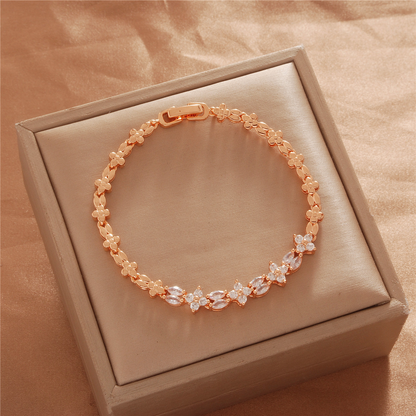 Gold Tone bracelet, style TSL033, with small flower-like accents and decorative links and a clasp.