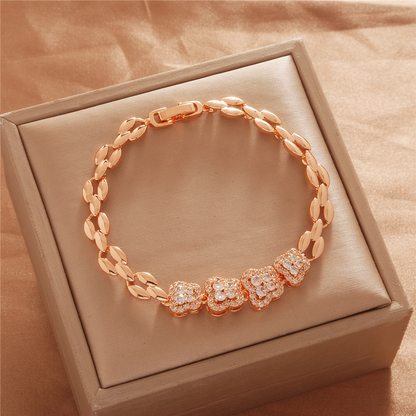Gold Tone bracelet, style TSL038, with small geometric flower-like center accents and leaf-shaped links and a clasp.