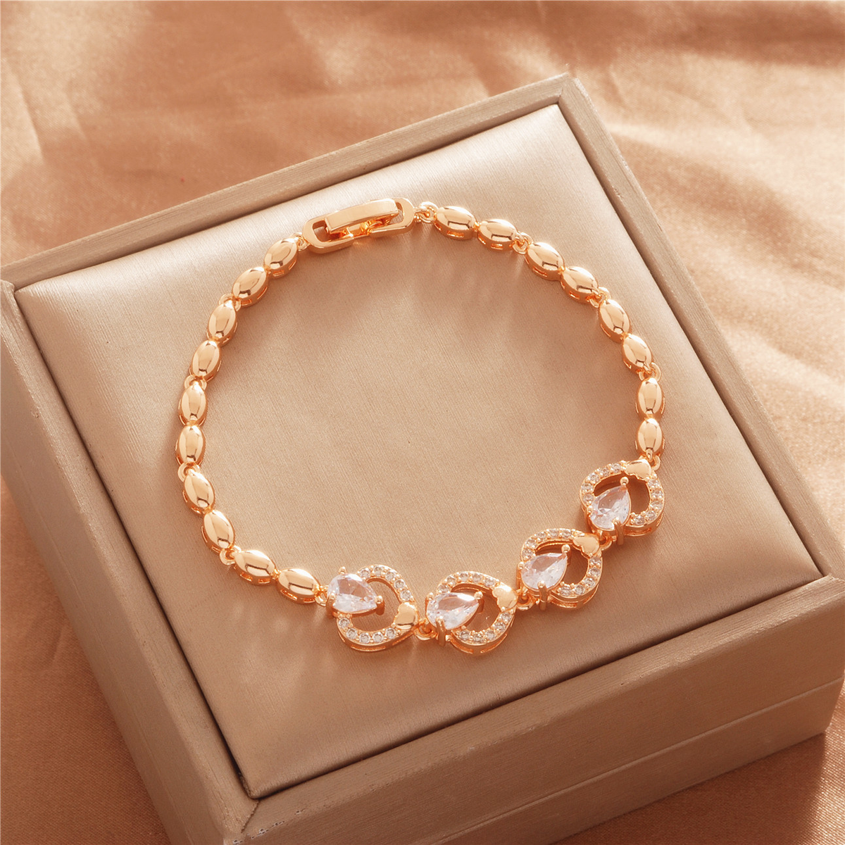 Gold Tone bracelet, style TSL042, with open round center motifs with clear accents and oval links and a clasp.