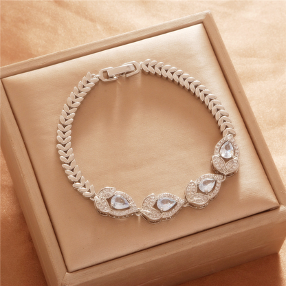 Silver Tone bracelet, style TSL043, with teardrop halo centers and chevron-like links and a clasp.